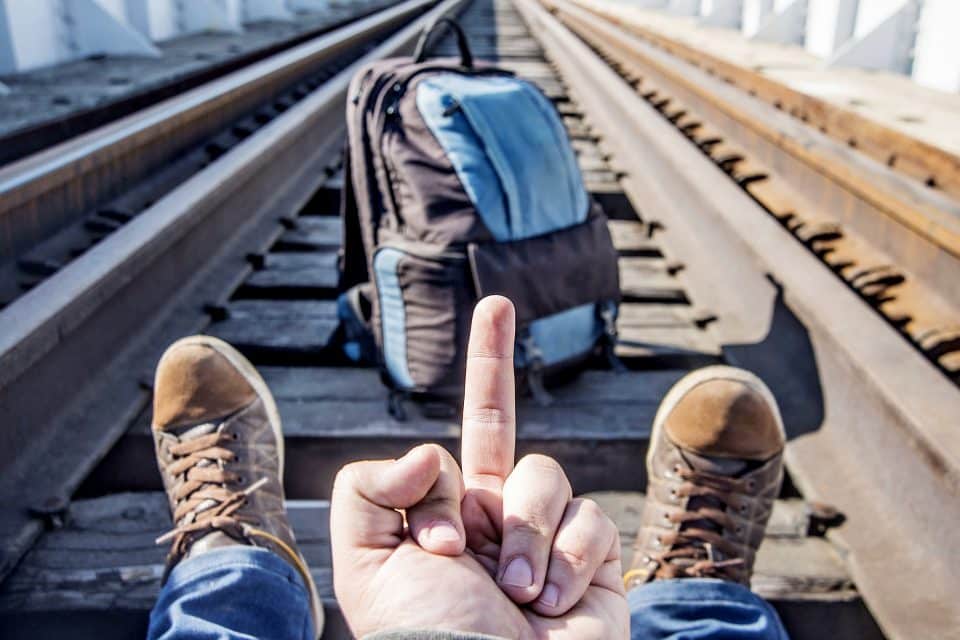 A man sitting on train tracks