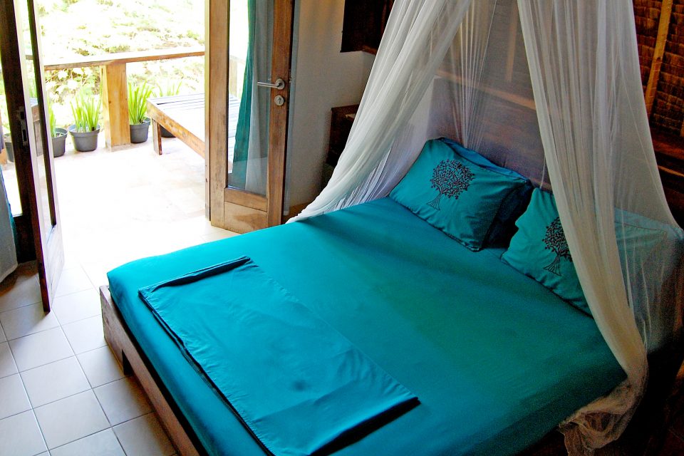 A double bed with an overhanging net