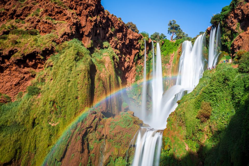 Rainbow shines over waterfall