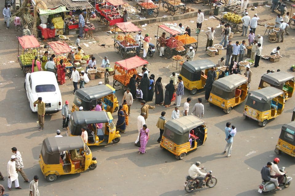 A bunch of auto rickshaws ride through India