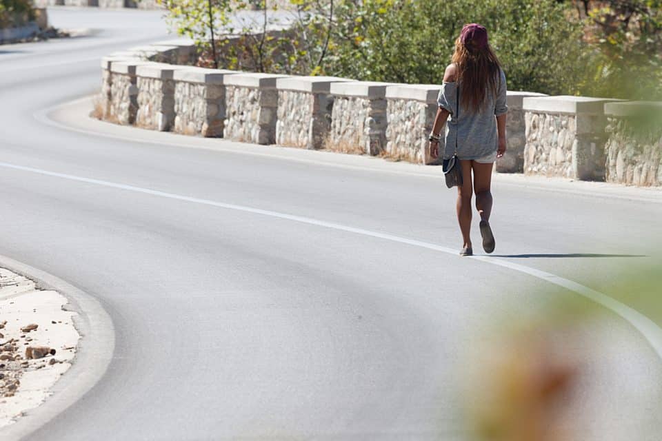 A woman walking on the road