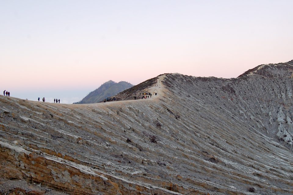 A group of people trekking over the volcano