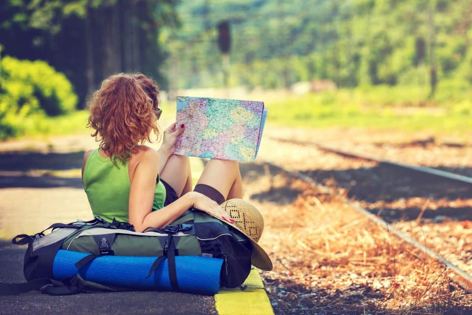 A female backpacker looking at a map