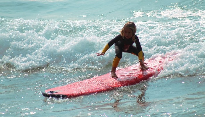 Unique Volunteer surfing kids camp