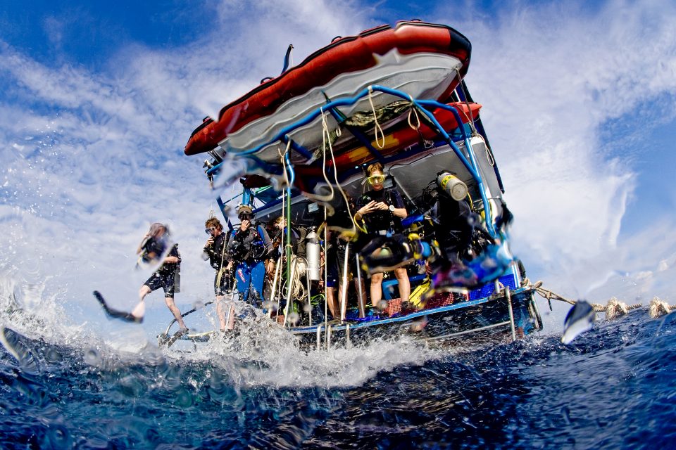Group of divers preparing to dive of a boat, Thailand