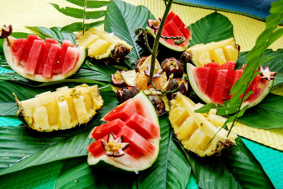 Watermelon and pineapple slices on banana leaves