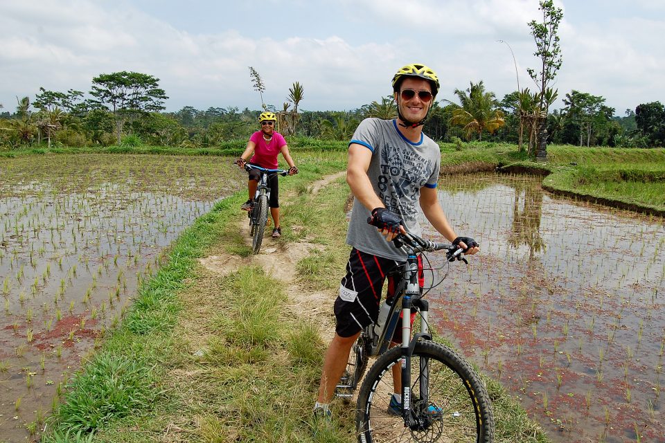 A couple cycling through the rice fields