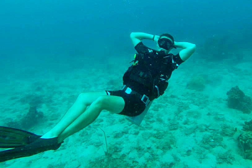 A male diver posing relaxed underwater