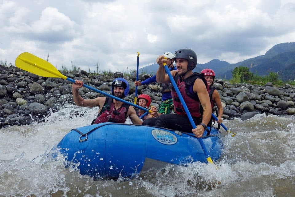 A group of people white water rafting