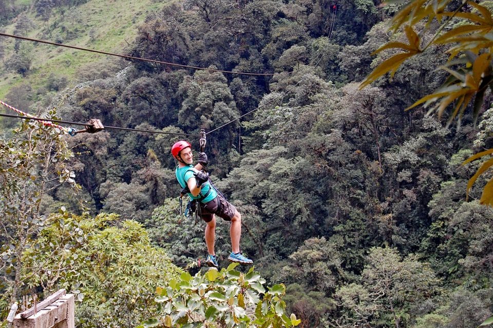 A man ziplining over the jungle