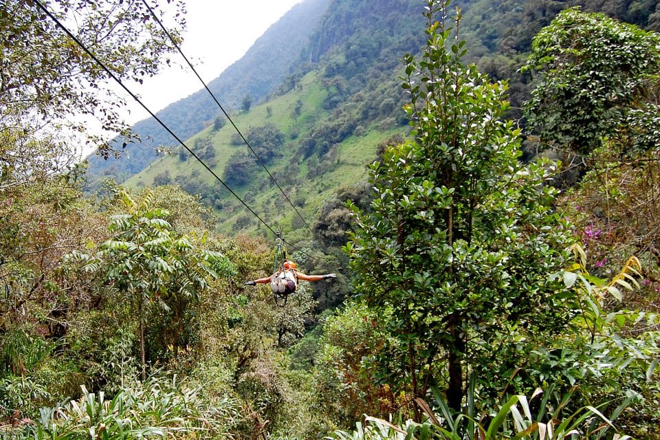 A man ziplining through the jungle