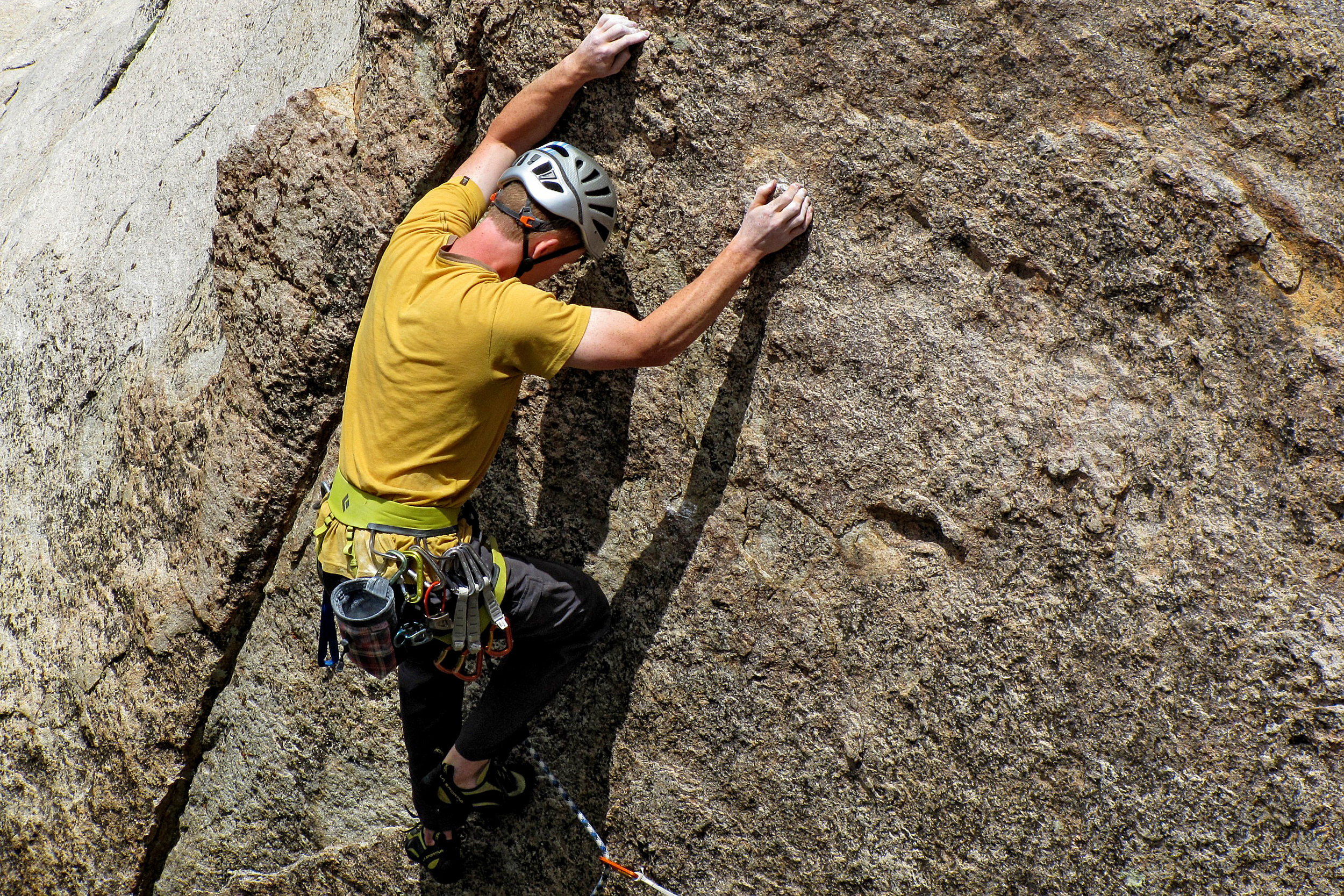 man rock climbing wall