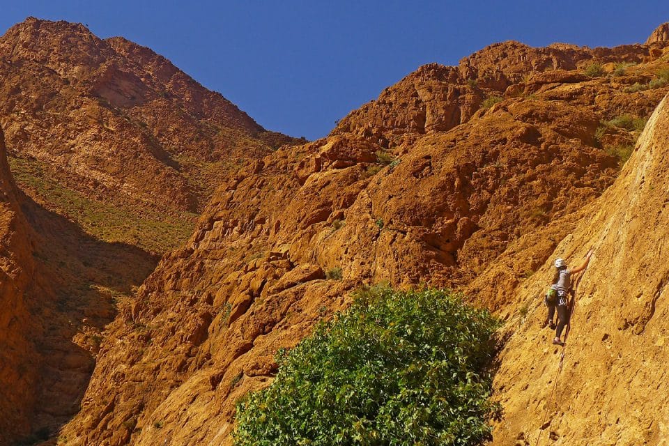 Girl climbs a rock in Morocco