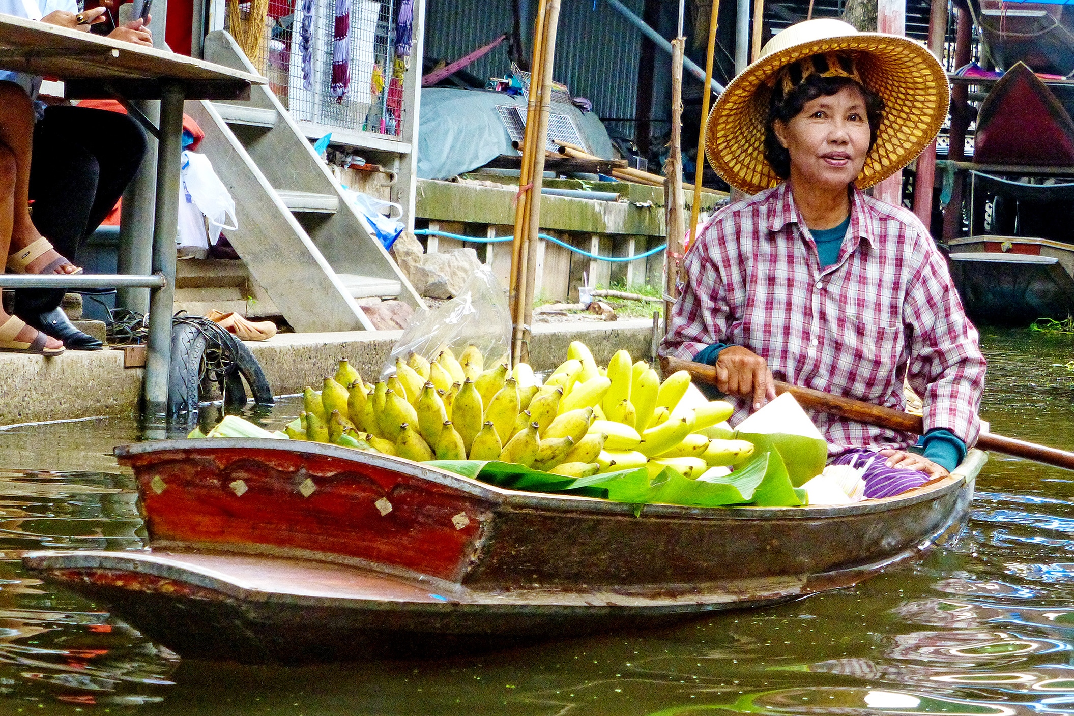Local woman selling bananas from a boat