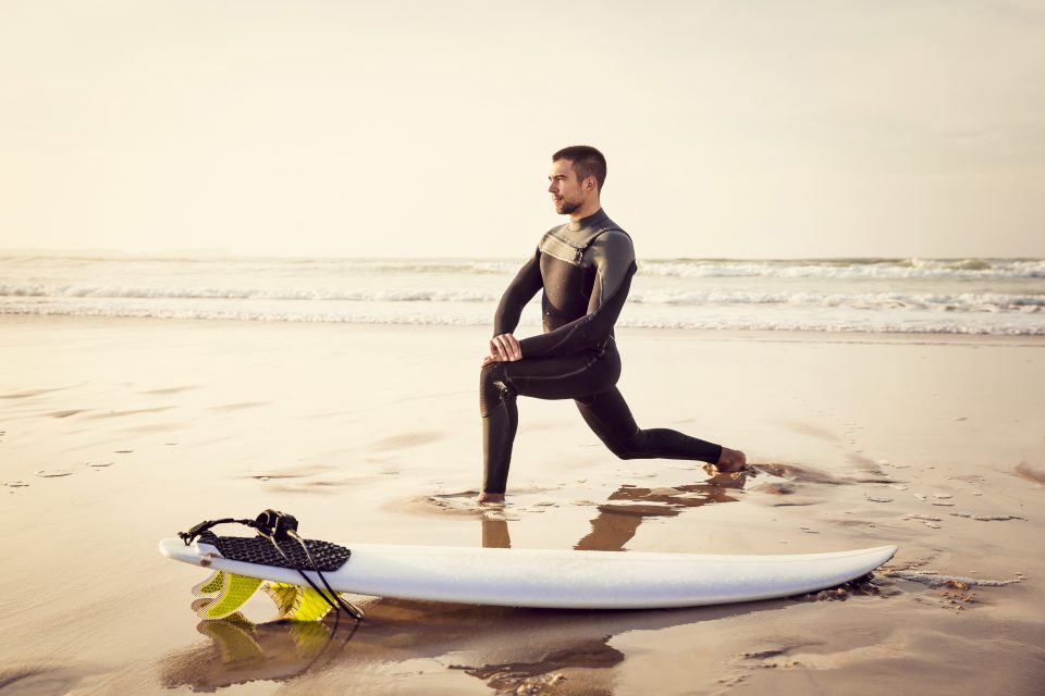 man stretching surf