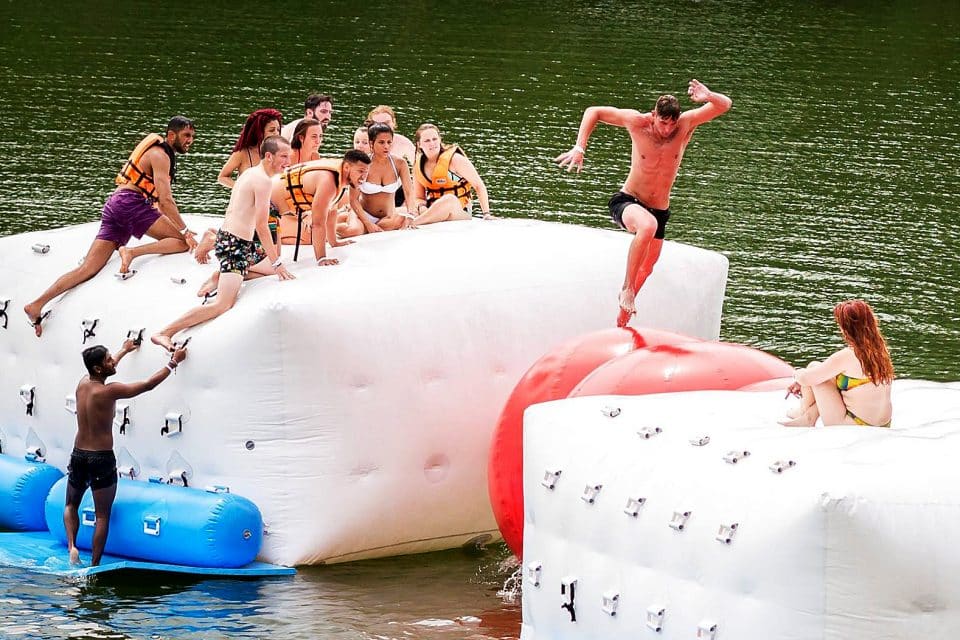 A group of people on an inflatable assault course