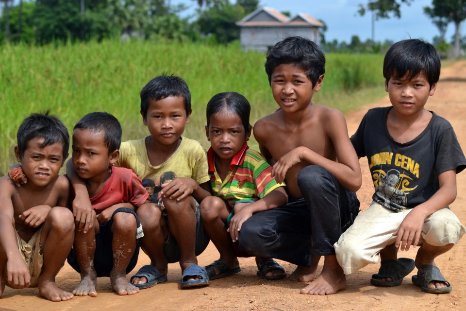 A group of local children crouching down
