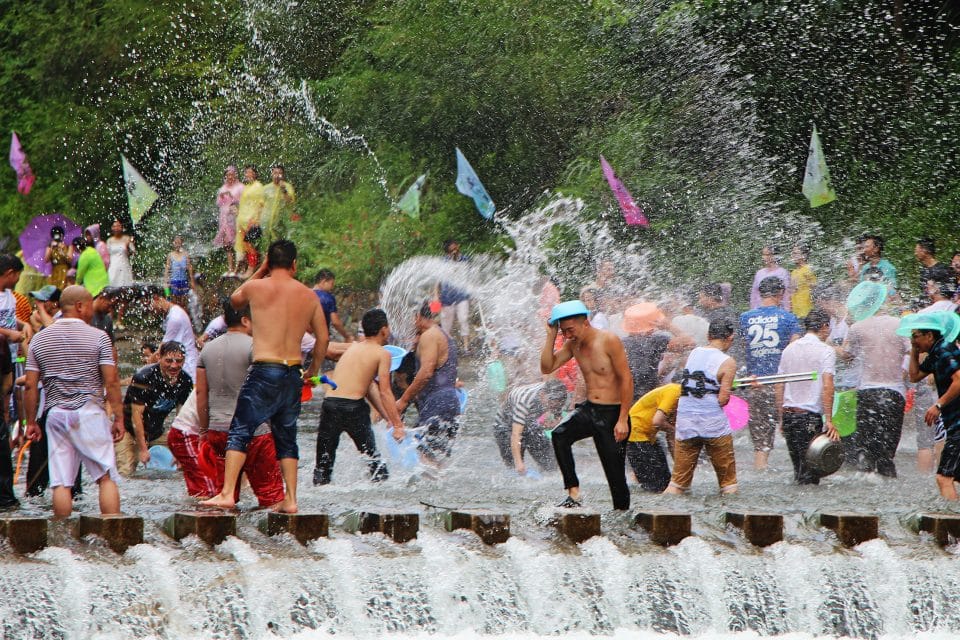 A group of people dancing in water fountains