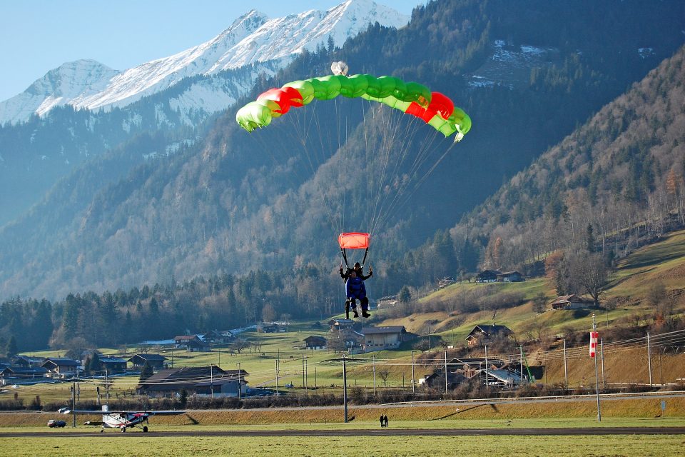 A skydiver landing in a field