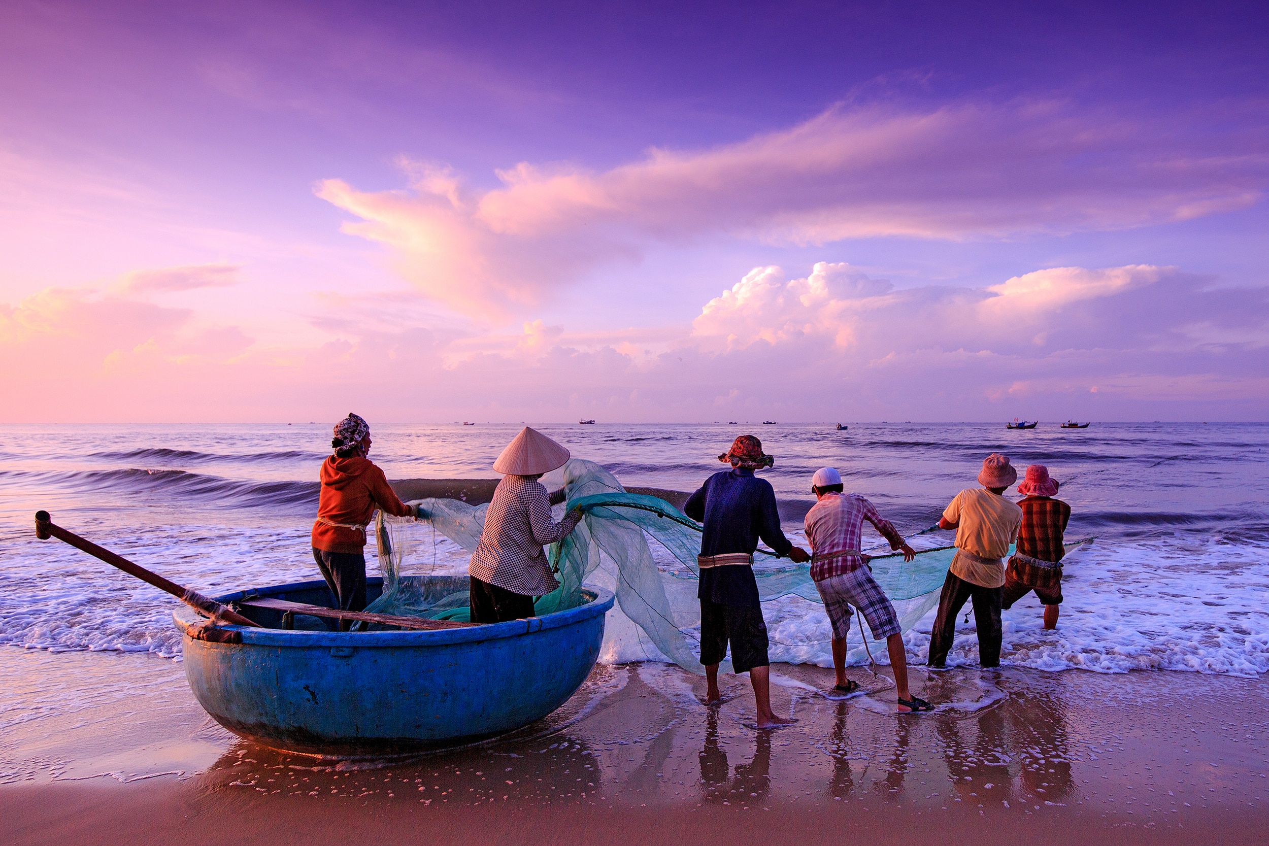 Fishermen casting a net in the sea