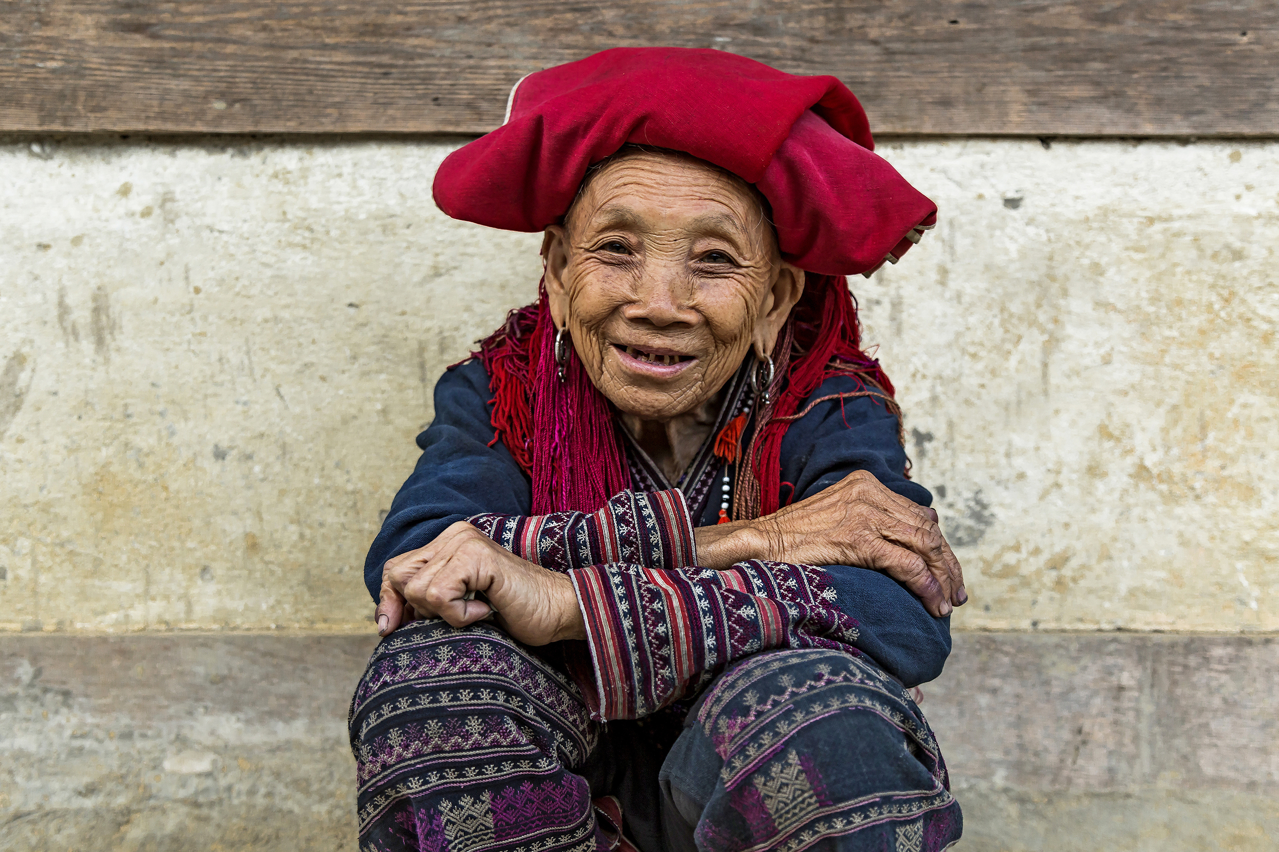 A local woman sitting and smiling