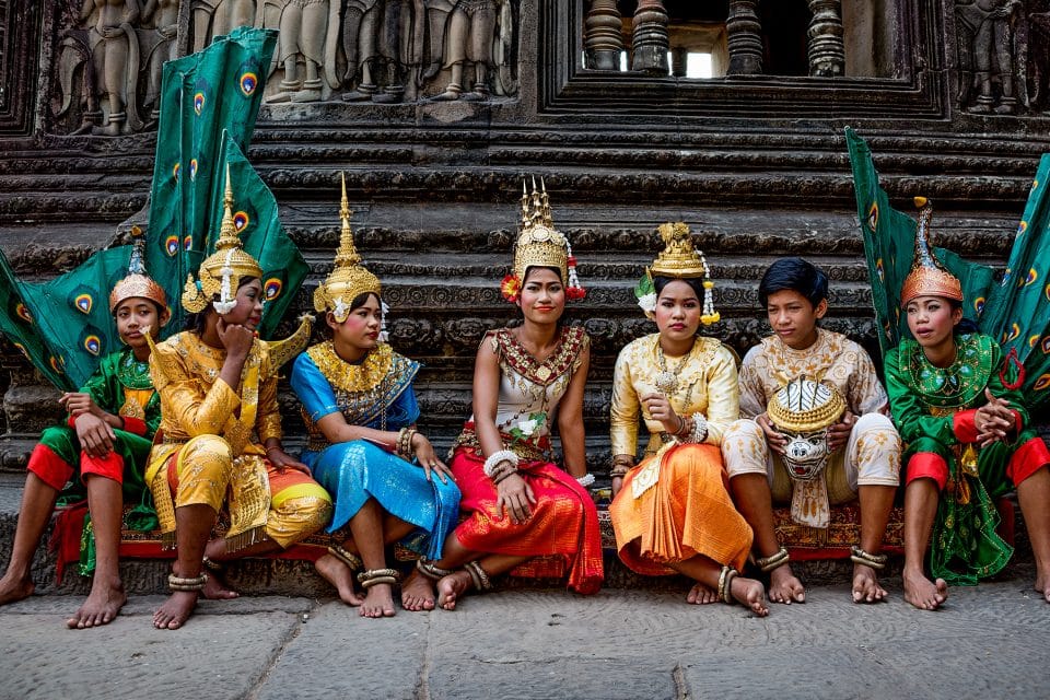 Local people sitting on steps in festival dress