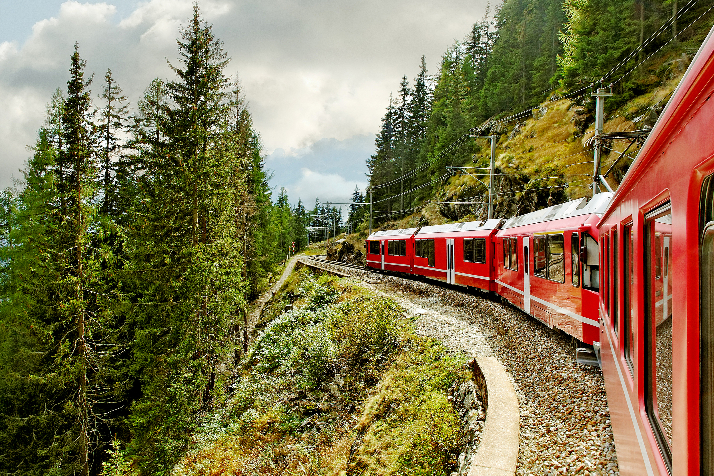A red train on the mountain edge