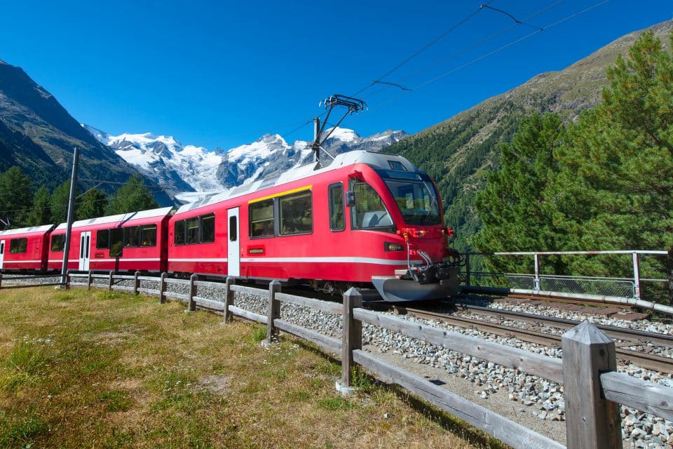 A red train through the mountains