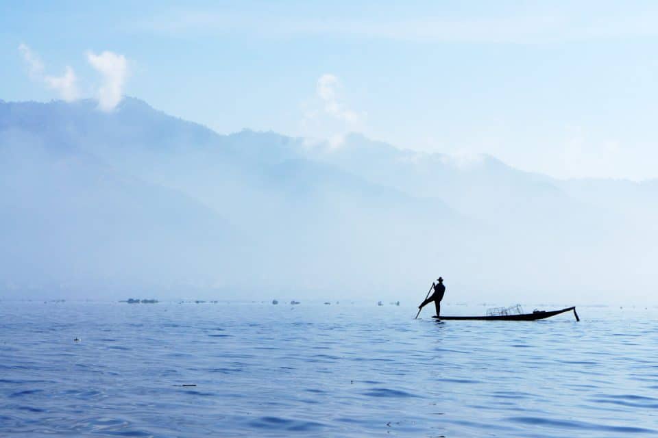Fisherman on a boat in Lake Inle in Myanmar