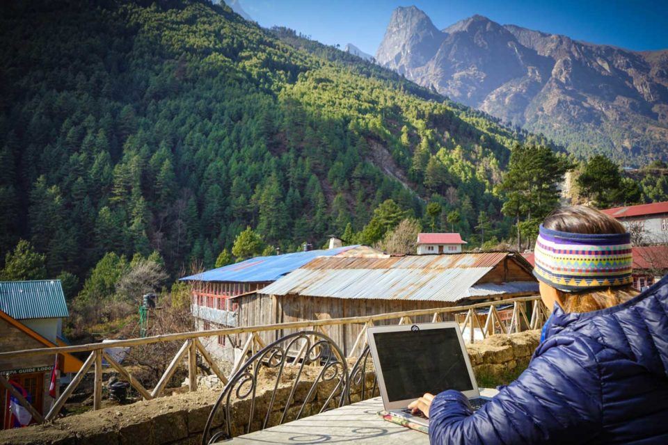 anna in nepal working on a laptop