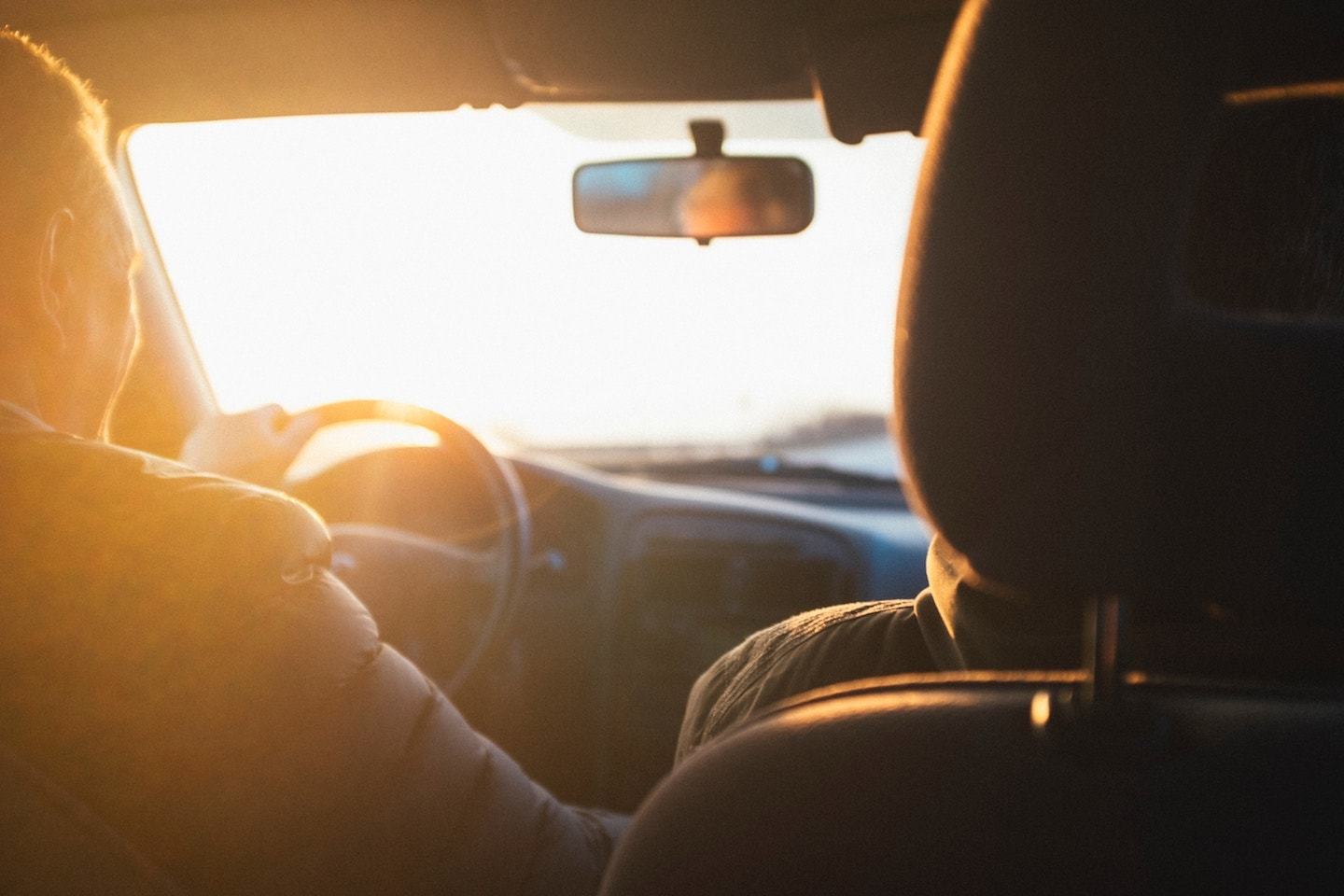 Two people driving during golden hour