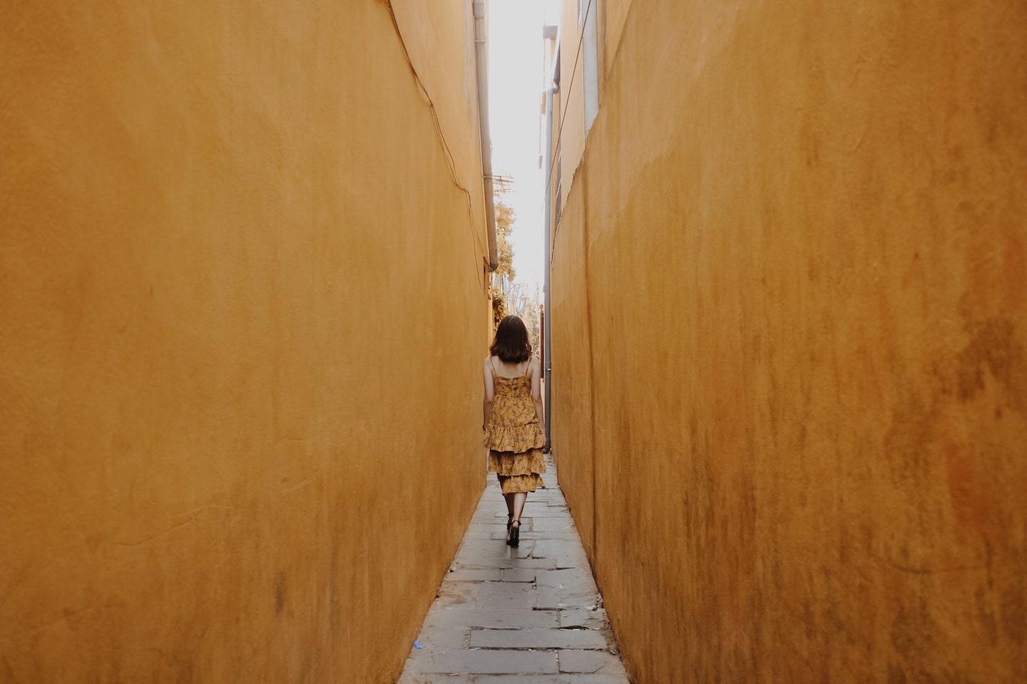 woman walking in alley