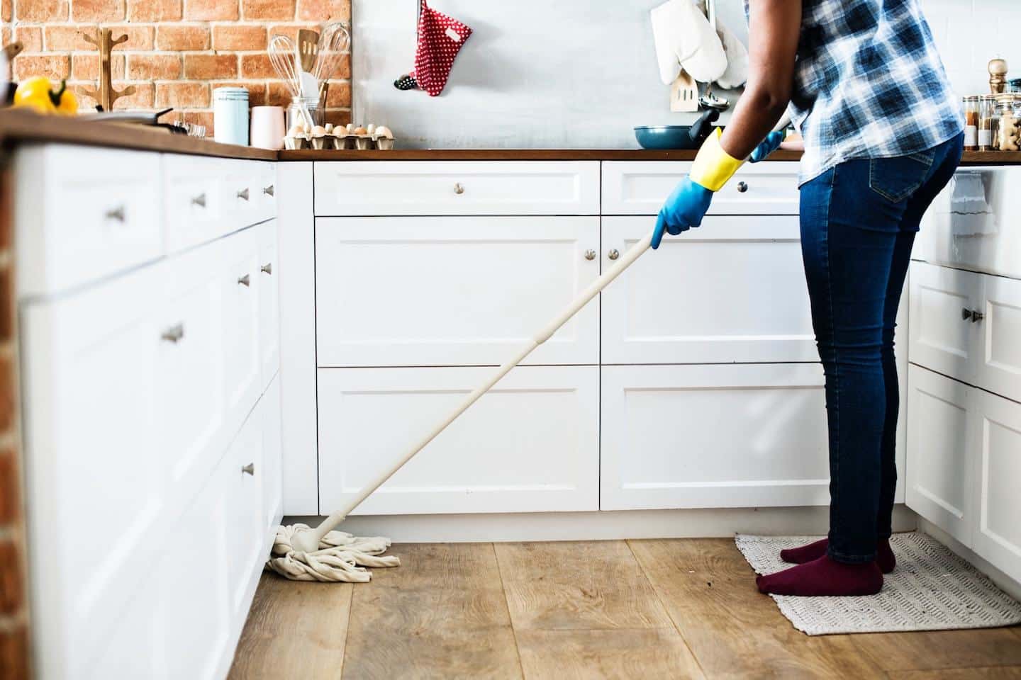 person mopping kitchen floor