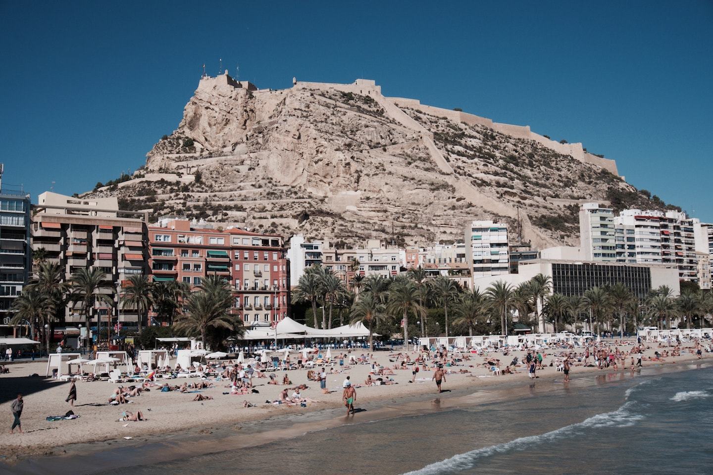beach surrounded by mountain and buildings in alicante spain