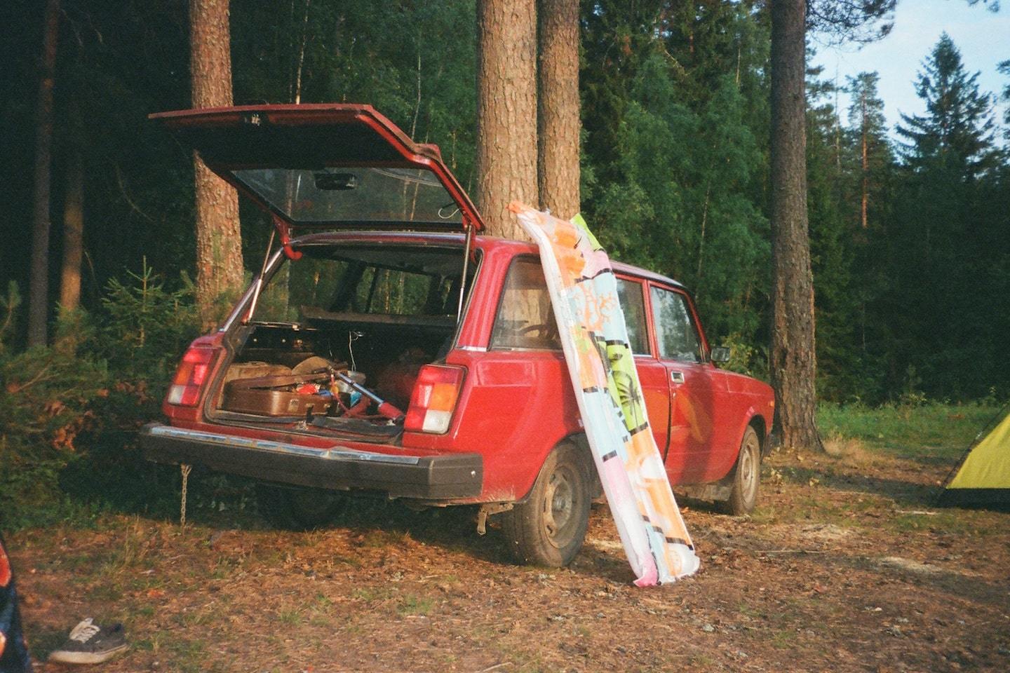 car with open trunk and camping equipment