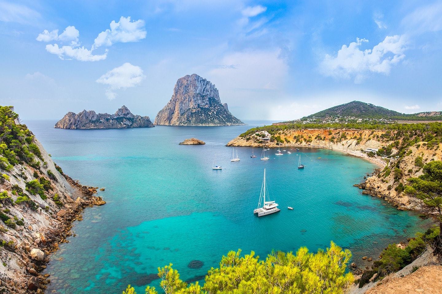 water with boats surrounded by mountains in ibiza spain