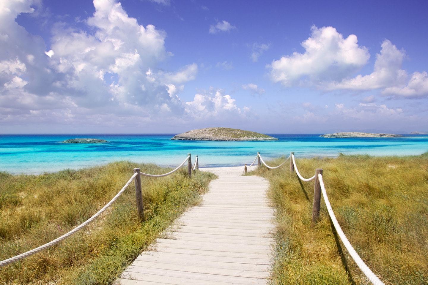 boardwalk to bright blue water on beach