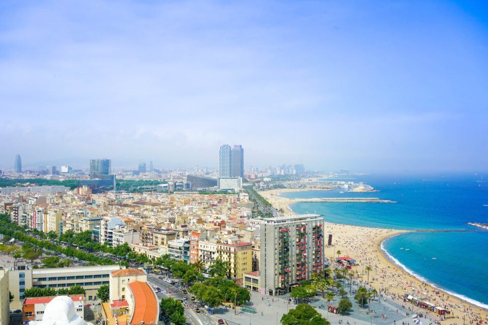 aerial view of city with beach and ocean in spain