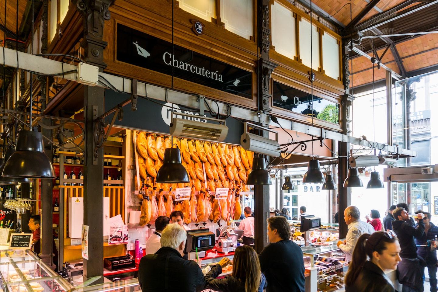 charcuterie counter at market in spain serving meat