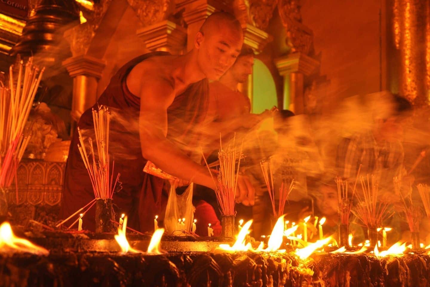 monk lighting candles