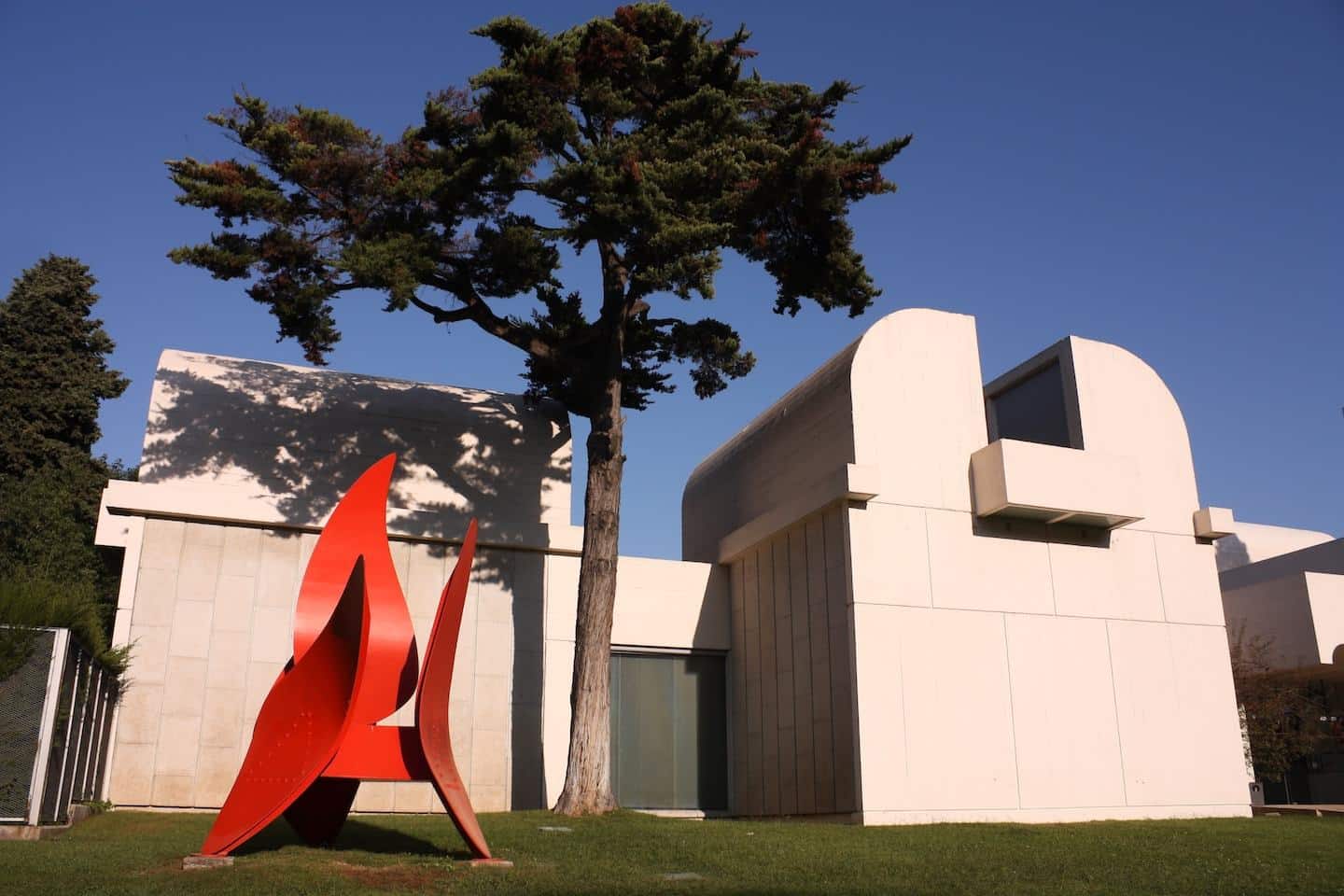 white barcelona museum with red sculpture outside