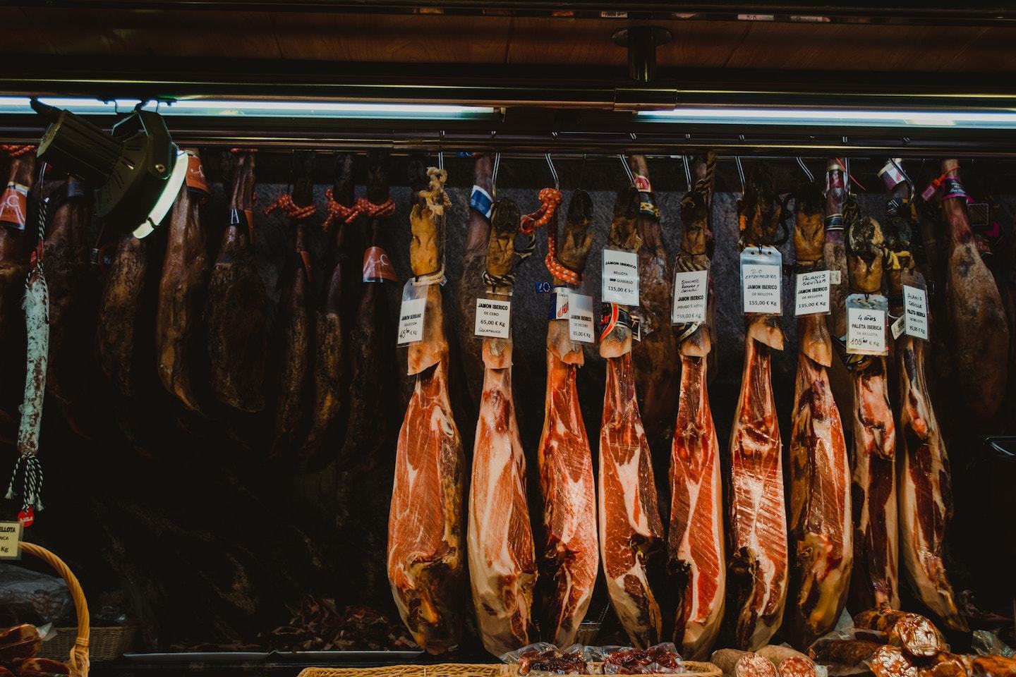 legs of cured meat hanging in spanish market