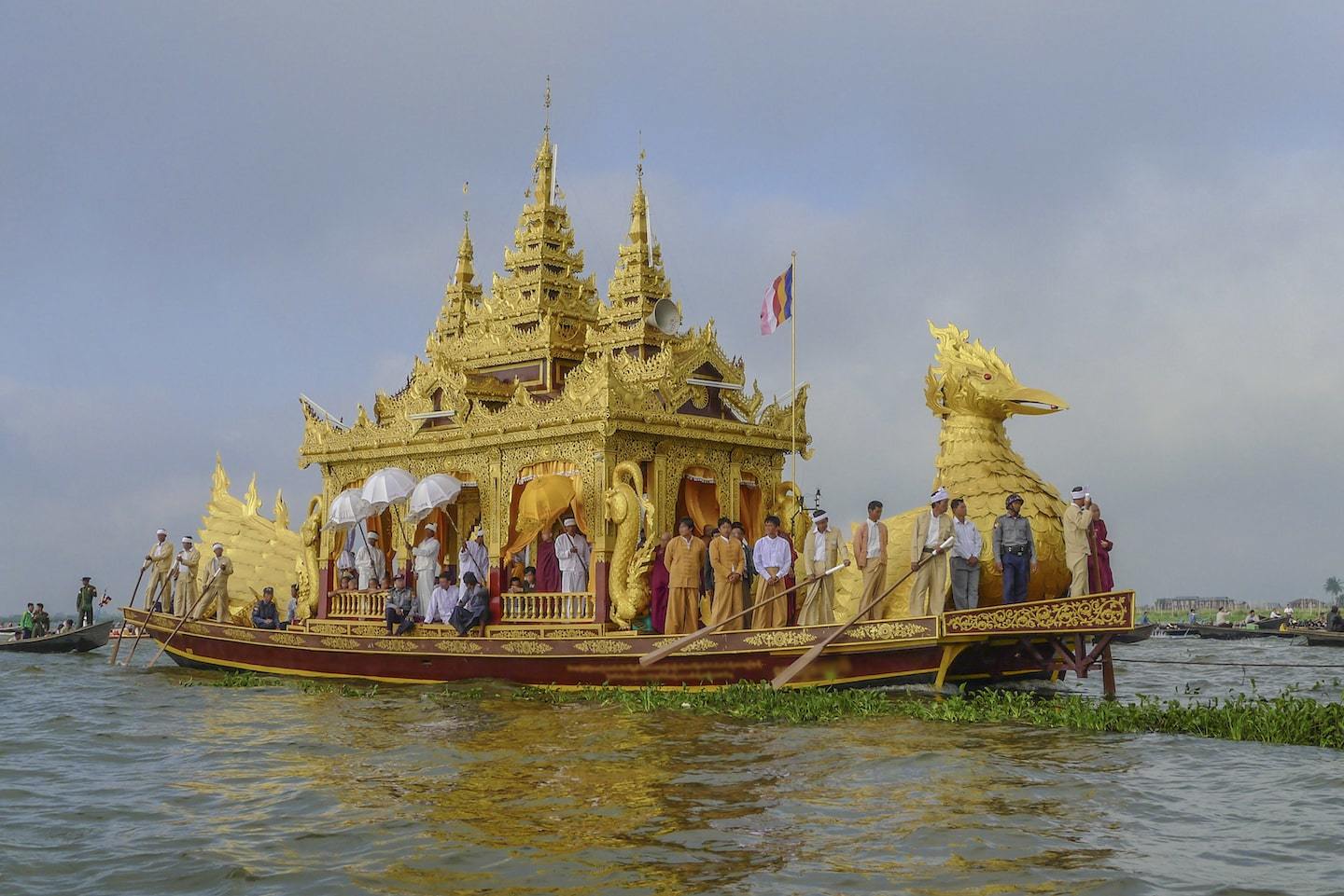 golden boat rowing on lake myanmar