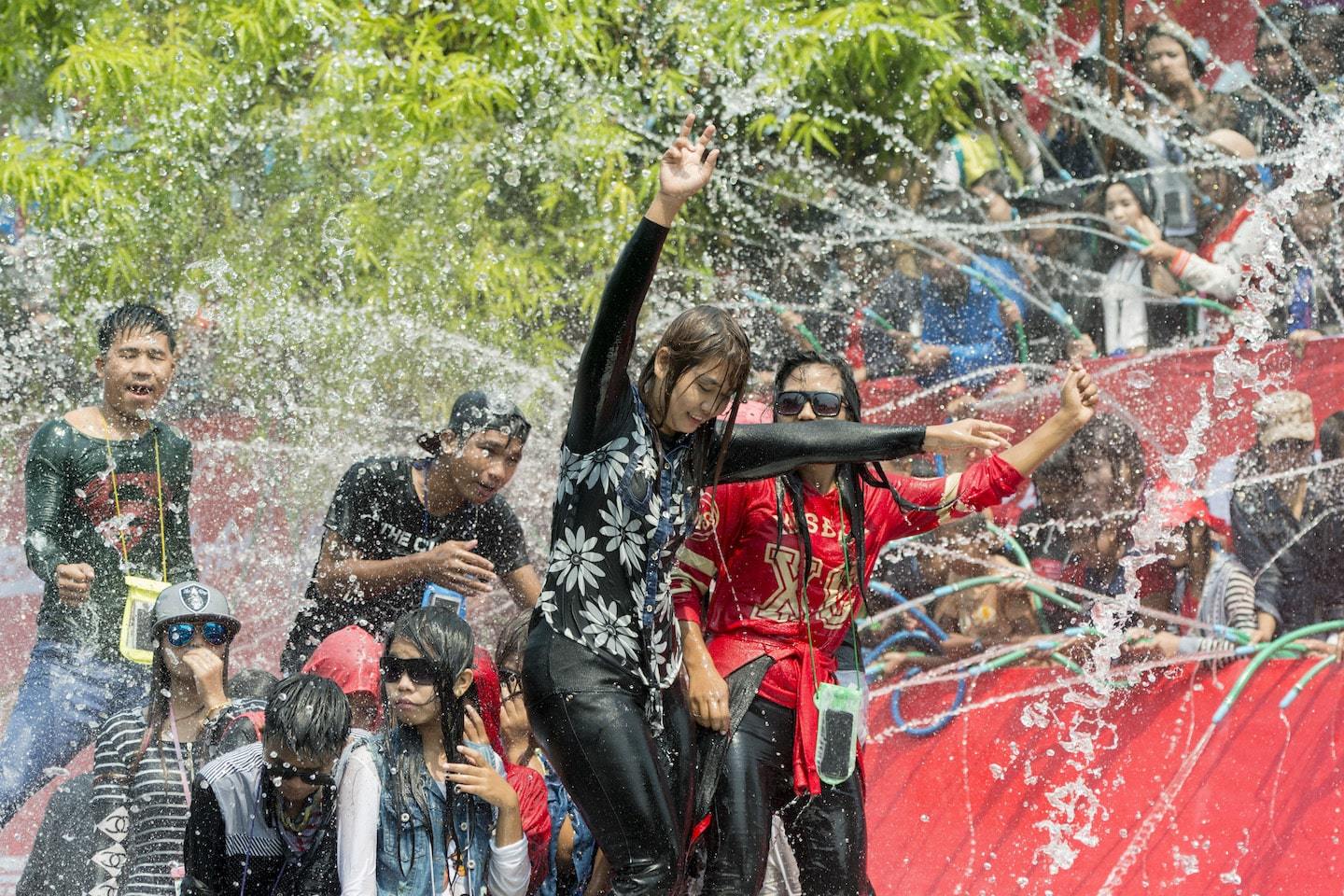 people throwing water on girl dancing in myanmar
