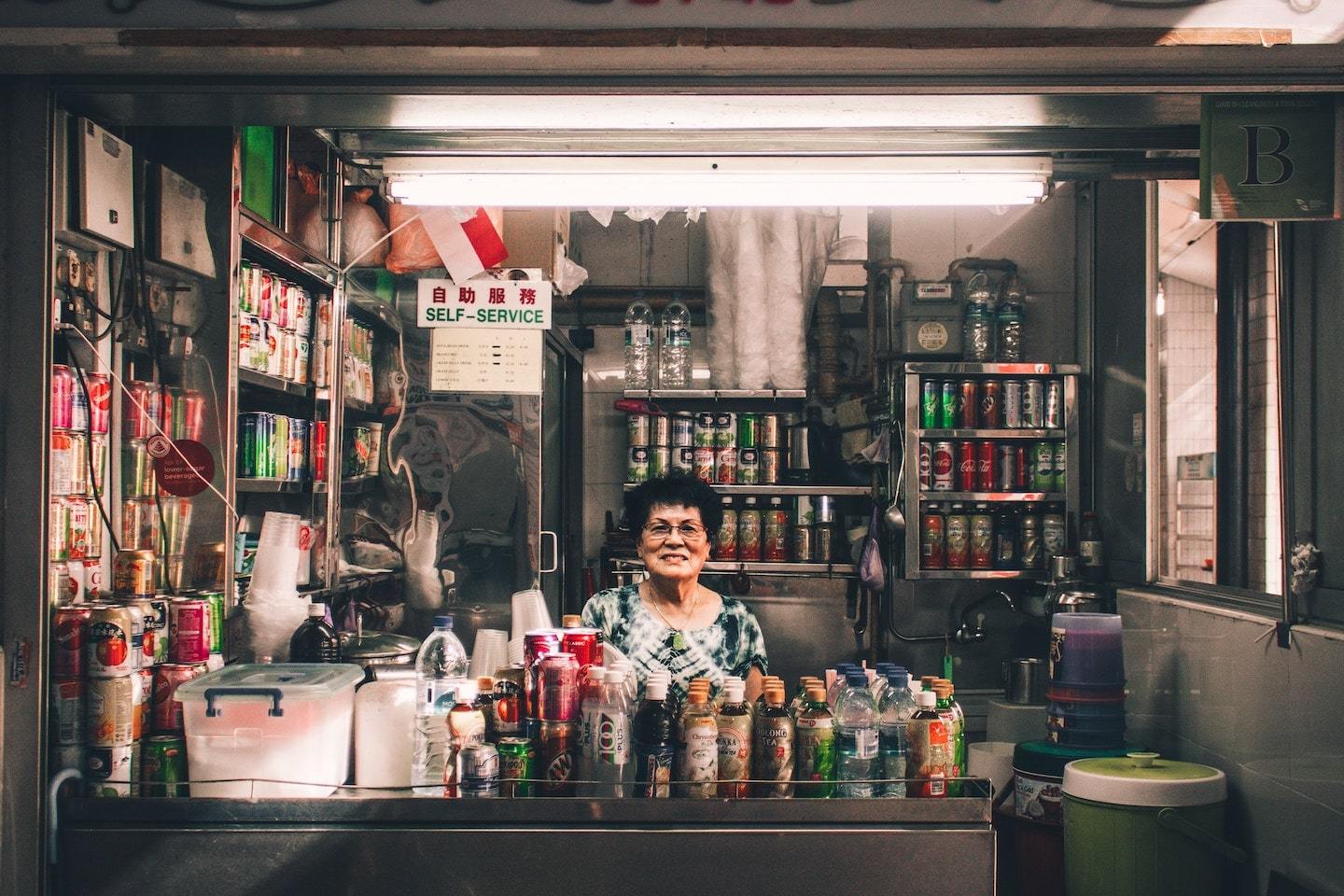 woman sitting in metal convenience store