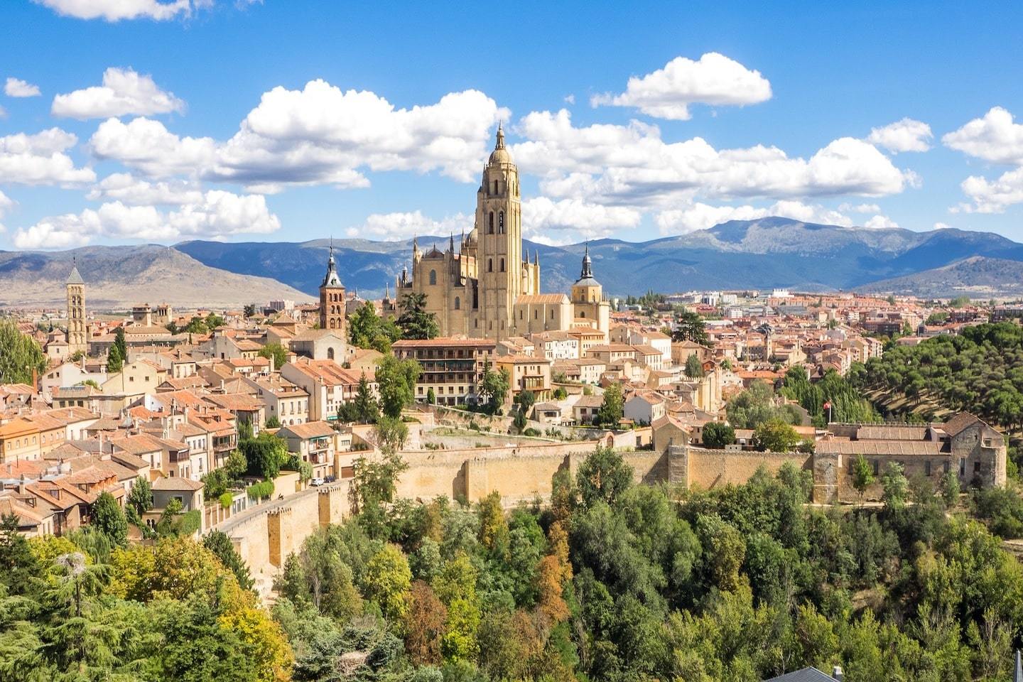 aerial view of Segovia with large church sticking out and blue sky