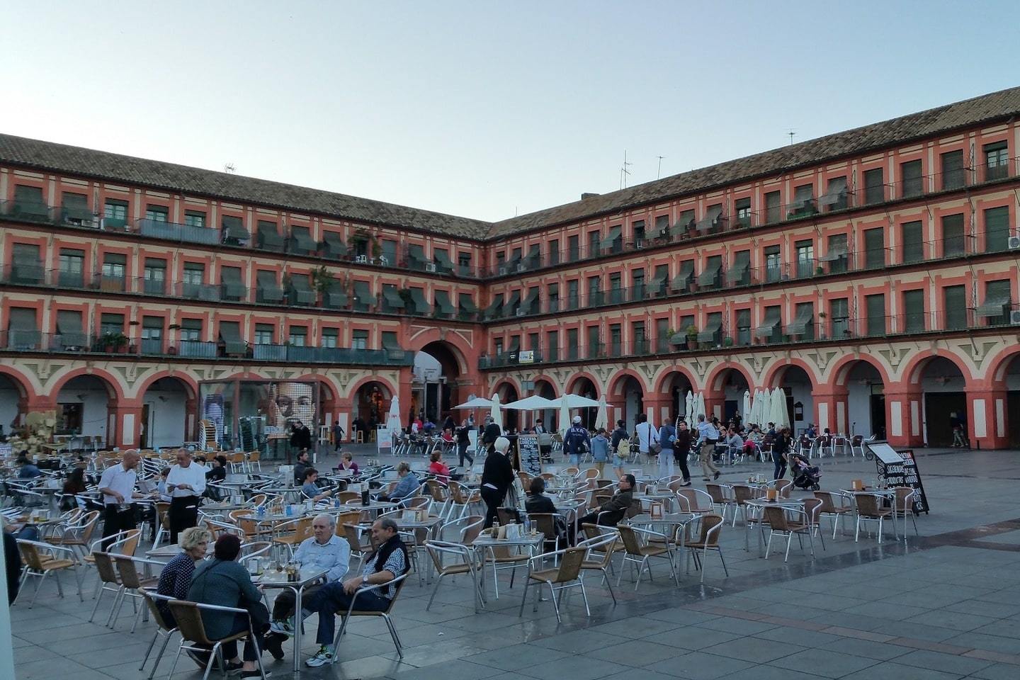 large plaza in Cordoba with people enjoying a meal or coffee