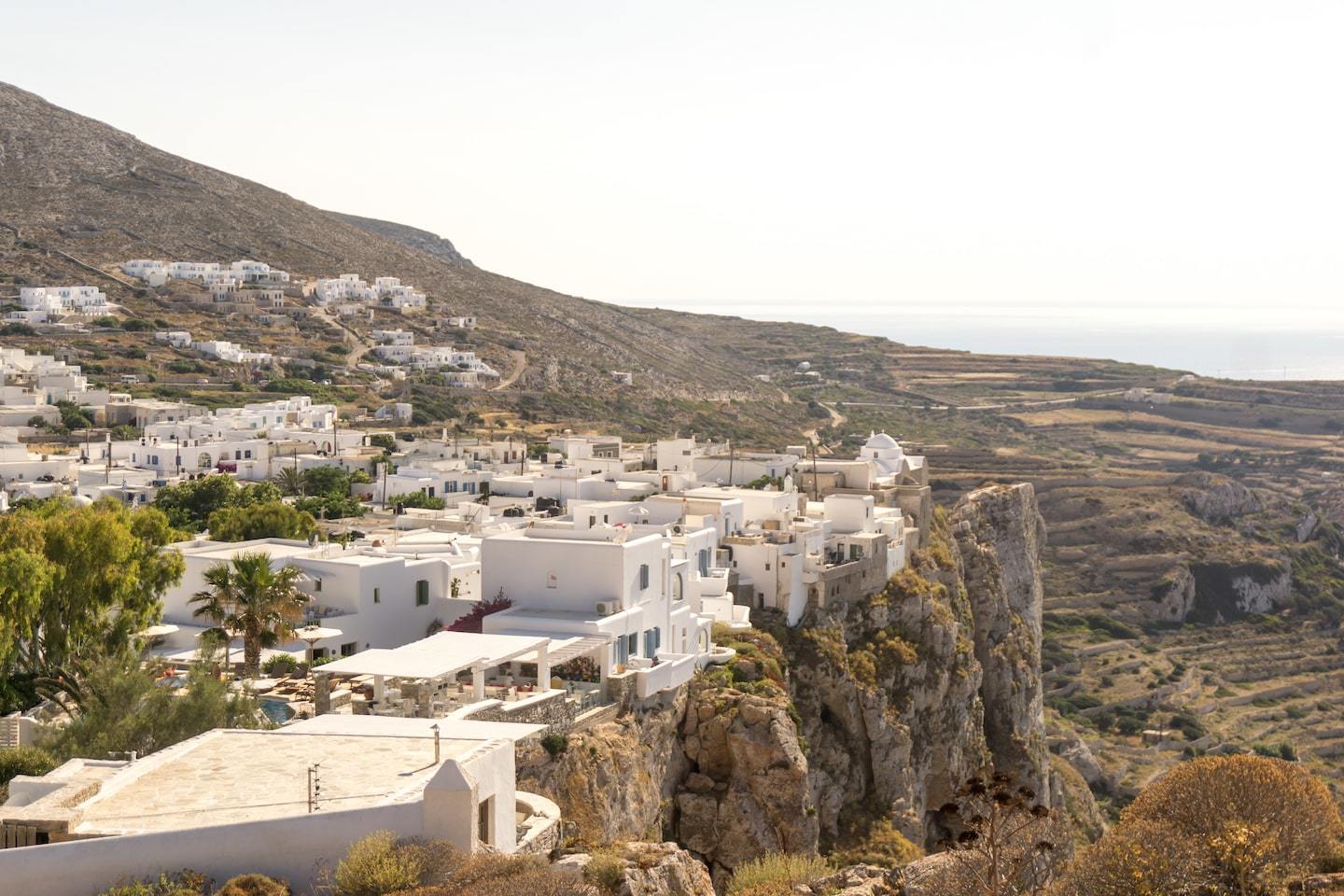 white washed town sitting on rocky crag in Folegandros greece
