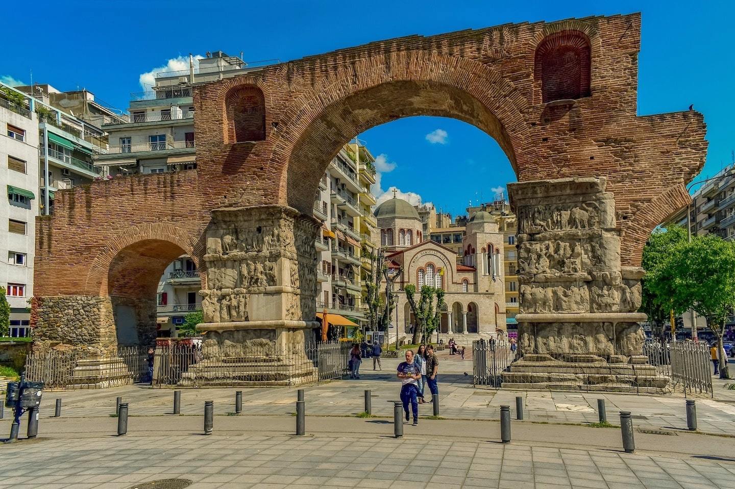 Where to Go in Greece: Remains of a Roman Bridge looking into the city under a blue sky in Thessaloniki, Greece.