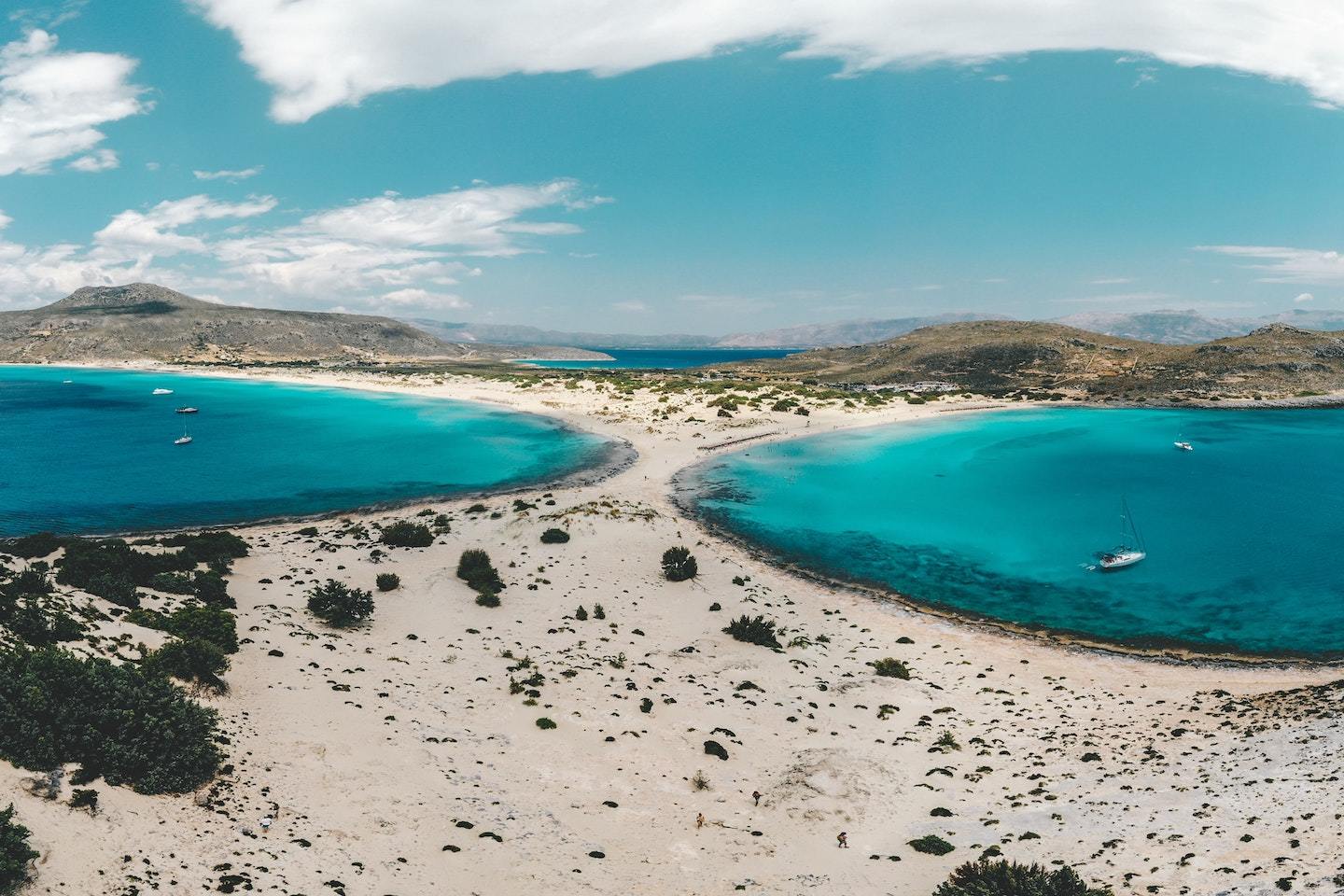 View of Simos Beach in Greece with water on both sides connected by a strip of sand